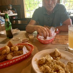 A shrimp and catfish basket; fried rice and catfish and Cajun fries.