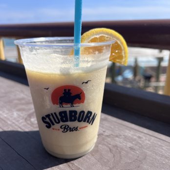 Stubborn Brothers - a drink with a straw and orange slice - New American Near Me - North Wildwood, New Jersey Stubborn Brothers - a drink with a straw and orange slice - New American Near Me - North Wildwood, New Jersey