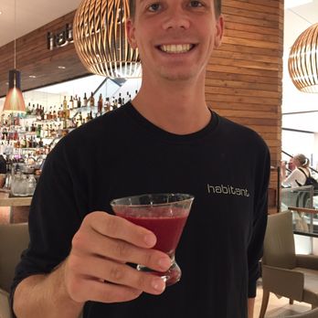 Habitant at Nordstrom - Our friendly server Garrett holding my Overtime! - Cocktail Bars Near Me - Honolulu, Hawaii