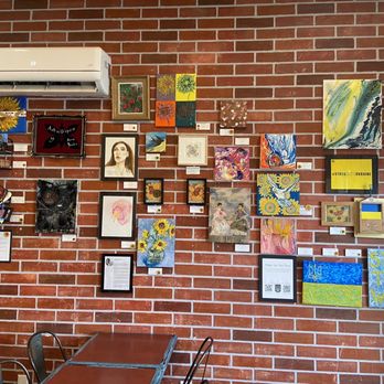 Cafe Amor & Art - a brick wall covered in art - Cafes Near Me - Windsor, Ontario Cafe Amor & Art - a brick wall covered in art - Cafes Near Me - Windsor, Ontario