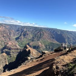 QM Taxi And Tours - Behold the vibrant hues of Waimea Canyon, Kauai's 'Grand Canyon of the Pacific,' where nature's masterpiece unfolds in stunning detail!