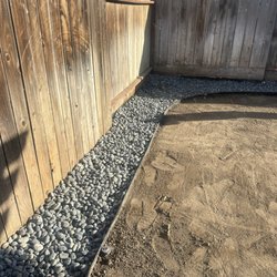 C Scott Construction & Landscaping - Beach pebble rock installation. Sod Grass preparation.