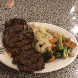 Plum Creek Restaurant - Ribeye cooked perfectly to medium rare. Butter grilled onions and grilled mixed vegetables.