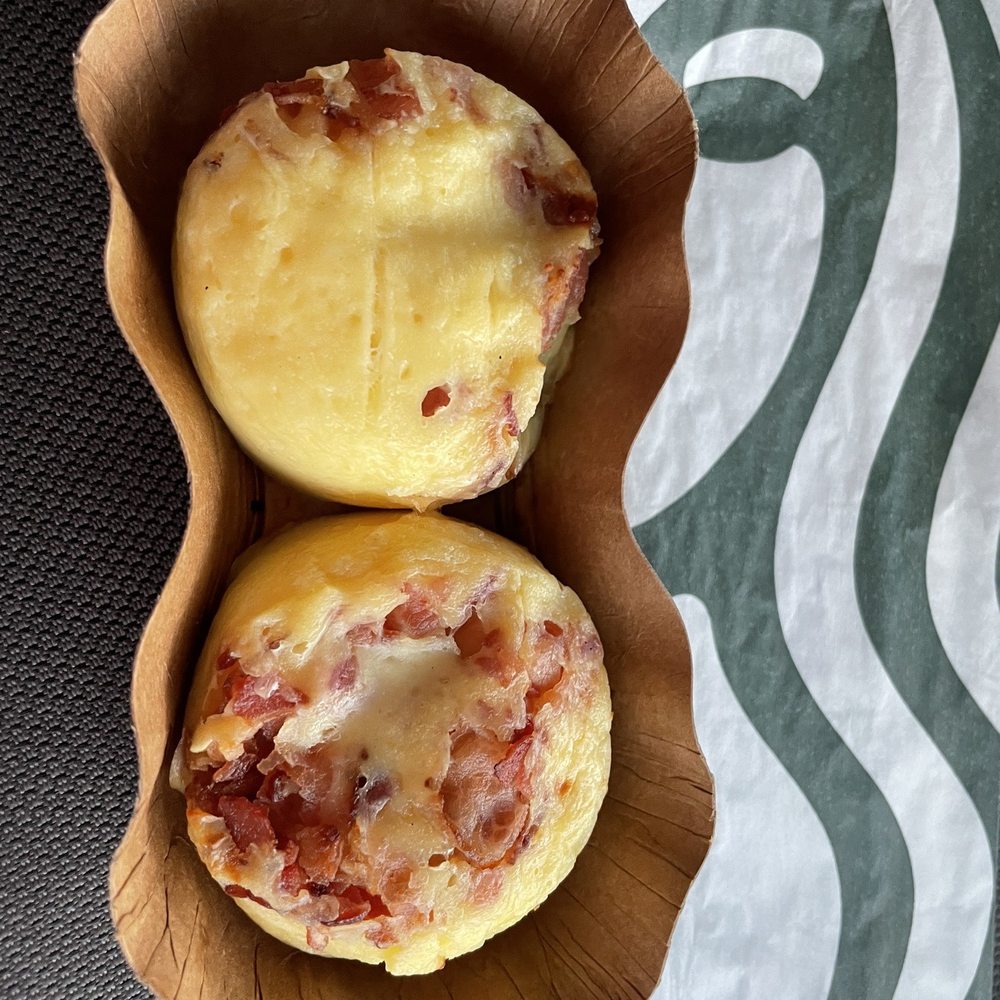 two muffins in a wooden bowl two muffins in a wooden bowl