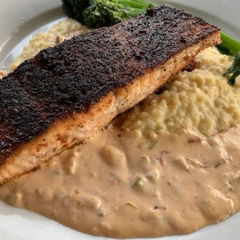 Grits Cafe - Blackened Salmon over a bed of chorizo, cheddar grits, and remoulade sauce - AMAZING - Southern Near Me - Forsyth, Georgia