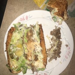 Completed ingredients on six inch of footlong Steak and Cheese Sub