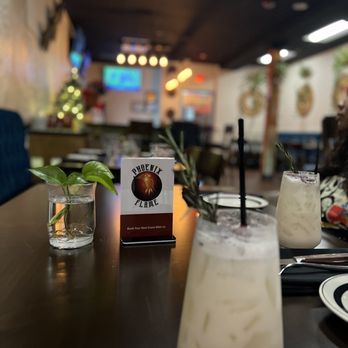 Phoenix Flame - a table with drinks and a menu - Latin American Near Me - Rolling Meadows, Illinois Phoenix Flame - a table with drinks and a menu - Latin American Near Me - Rolling Meadows, Illinois