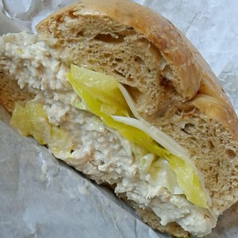 Bagels Plus - This is the remaining half of chicken salad on a sun-  dried tomato bagel w/ Swiss cheese, lettuce, and Banana peppers. - Bagels Near Me - Tampa, Florida