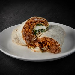 Fuego Cravings - Stuffed with fluffy rice, hearty beans, savory asada, a homemade chile relleno straight from Puebla, Mexico, sour cream, cotija cheese.