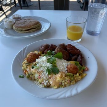 Phoebe's Diner - Migas and two pancakes. Migas is scrambled eggs with veggies and hatch chiles, potatoes and other goodies. - Breakfast & Brunch Near Me - Austin, Texas Phoebe's Diner - Migas and two pancakes. Migas is scrambled eggs with veggies and hatch chiles, potatoes and other goodies. - Breakfast & Brunch Near Me - Austin, Texas