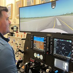 Aviator NYC - Flight simulator lesson in NYC with cockpit controls, runway visuals, and instructor-led aviation training.