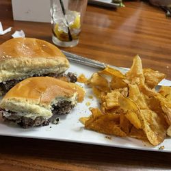Black and blue burger with homemade chips.