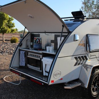 Best RV Vacation - The T@G Boondock kitchen. Gas hotplate, YETI cooler, microwave and sink. Also speakers for music, light strip and ceiling light. - RV Rental Near Me Best RV Vacation - The T@G Boondock kitchen. Gas hotplate, YETI cooler, microwave and sink. Also speakers for music, light strip and ceiling light. - RV Rental Near Me
