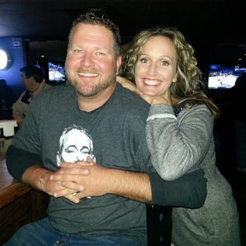 Tapz Pub - a man and a woman hugging at a bar - Pubs Near Me - Clive, Iowa