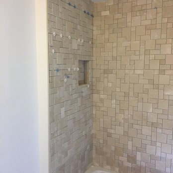 J.A.G.S Contracting - Natural stone mosaic tub surround with new tub and fixtures - General Contractors Near Me