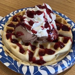 Hot Waffle with Nutella flavored custard, whipped cream and raspberry sauce. Delicious!