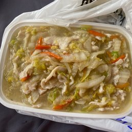 a plastic container filled with soup