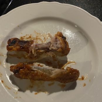 Frontier Club - two pieces of chicken on a white plate - Sports Bars Near Me - Aurora, Colorado