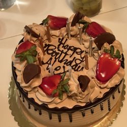 Josie's Bakery - Trees leches coffee Cake with strawberries and candles.
