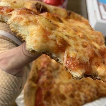Palumbo’s Pizza - a hand holding a slice of pizza - Pizza Near Me - East Stroudsburg, Pennsylvania Palumbo’s Pizza - a hand holding a slice of pizza - Pizza Near Me - East Stroudsburg, Pennsylvania