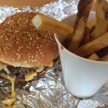 Five Guys - Cheeseburger and half of the small order of fries. The fry overflow is still in the bag! - Burgers Near Me - Issaquah, Washington
