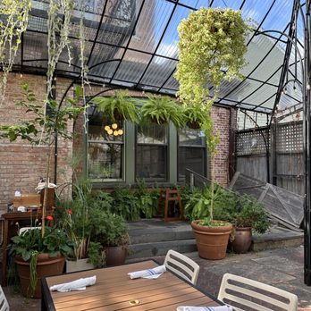 Le Perche - a patio with a table and chairs - French Near Me - Hudson, New York Le Perche - a patio with a table and chairs - French Near Me - Hudson, New York