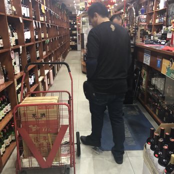 Prince Street Wine & Liquor - a man pushing a shopping cart - Beer, Wine & Spirits Near Me - Flushing, New York