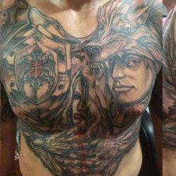 Dudes Tattoos - Armored warrior and heraldic shield chest tattoo with cultural motifs from Dudes Tattoos - Bronx, NY warrior-tiger-wolf-heraldic-chest