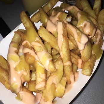 La Burguesa - a plate of french fries with cheese sauce - Hot Dogs Near Me - Miami, Florida La Burguesa - a plate of french fries with cheese sauce - Hot Dogs Near Me - Miami, Florida