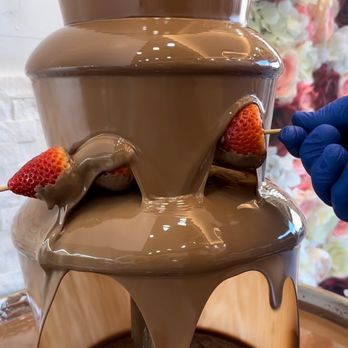 Chocolate House - a chocolate fountain with strawberries on top - Desserts Near Me - Bronx, New York