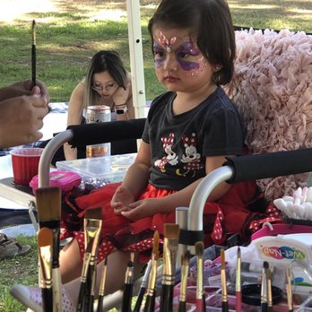 Sunflower Face Painting - Sitting patiently with the artist - Face Painting Near Me