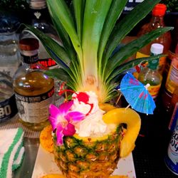 Catramex Restaurant - Tropical pineapple drink served at Catramex Restaurant featuring a refreshing handcrafted cocktail presented inside a fresh p...