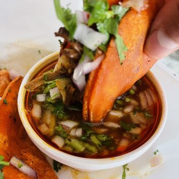 Don Taco & Ice Cream Land - a person dipping a sweet potato into a bowl - Ice Cream & Frozen Yogurt Near Me - Elgin, Illinois Don Taco & Ice Cream Land - a person dipping a sweet potato into a bowl - Ice Cream & Frozen Yogurt Near Me - Elgin, Illinois