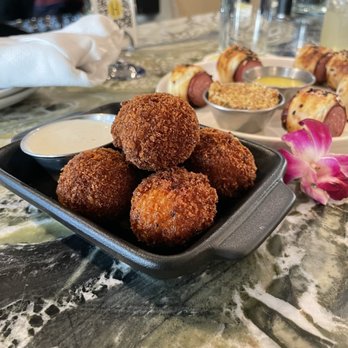 Hide - Pimento cheese balls with pigs in a blanket in the background - Cocktail Bars Near Me - Dallas, Texas