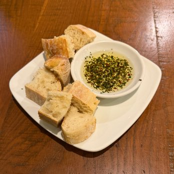 California Pizza Kitchen - Complementary sourdough bread and olive oil with herbs and spices - Pizza Near Me - Brea, California