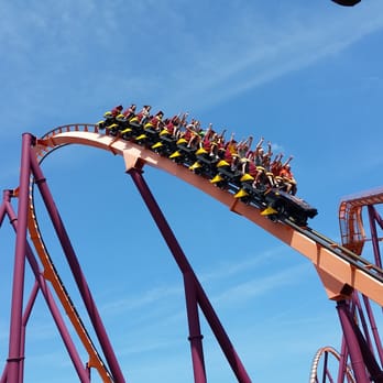 Raging Bull - The yellow train navigates a fan curve before dipping under the lift hill. Note the hands in the air! - Amusement Parks Near Me - Gurnee, Illinois Raging Bull - The yellow train navigates a fan curve before dipping under the lift hill. Note the hands in the air! - Amusement Parks Near Me - Gurnee, Illinois