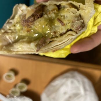 Victorico’s Mexican Food - a person holding a burrito - Mexican Near Me - Longview, Washington Victorico’s Mexican Food - a person holding a burrito - Mexican Near Me - Longview, Washington