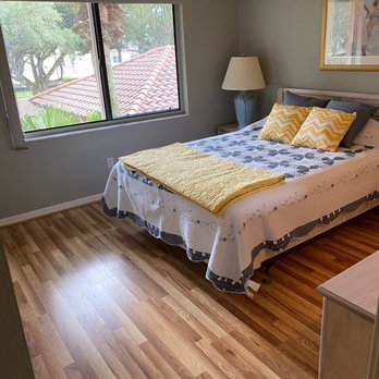 Preferred Flooring Installations - a bedroom with hardwood floors - Flooring Near Me