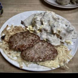 Biscuits & gravy with sausage patties, scrambled eggs, and hash browns.