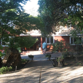 Tulocay Winery - a man standing in front of a house - Wineries Near Me - Napa, California