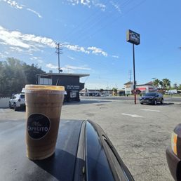 Cafe de olla and the outside parking lot of the store front. Cafe de olla and the outside parking lot of the store front.