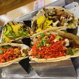 a variety of tacoss on a tray