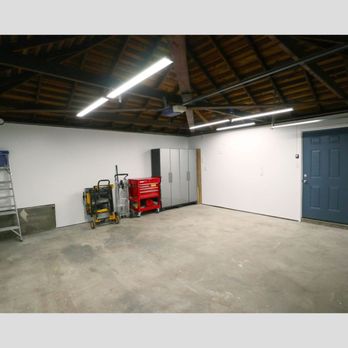 Comstruct Builders - Garage after replacing swing door, drywalling, and painting. - General Contractors Near Me