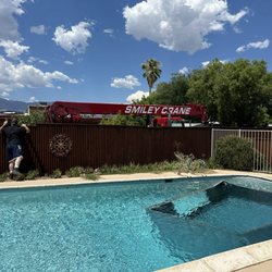 Smiley Crane Service - A micro burst put the neighbors shed in our pool. How to get it out without damaging the plaster? Smiley's crane did a great job!
