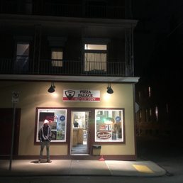 a man standing in front of a restaurant a man standing in front of a restaurant