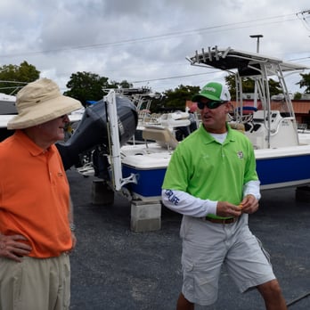 Boater's Landing - Mark Erstling, in green, LISTENS carefully to his customers requirements for a boat. - Boat Dealers Near Me - Fort Myers, Florida