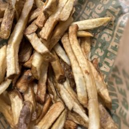 a pile of french fries in a basket