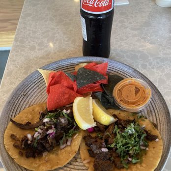 Almaya - Two tacos de asada with colorful seasoned chips and a red toasted salsa very spicy but flavorful. - Mexican Near Me - Los Angeles, California Almaya - Two tacos de asada with colorful seasoned chips and a red toasted salsa very spicy but flavorful. - Mexican Near Me - Los Angeles, California