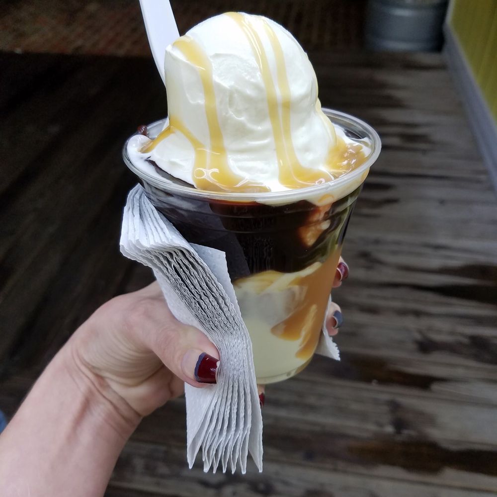 Cha Cha's Custard & More - a hand holding a cup of ice cream - Ice Cream & Frozen Yogurt Near Me - Foxworth, Mississippi
