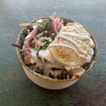 Casa Playa - Carnitas breakfast bowl with 2 eggs over easy pickled red onion crema and cilantro on top of home potatoes aka casa potatoes. - Mexican Near Me - Redondo Beach, California
